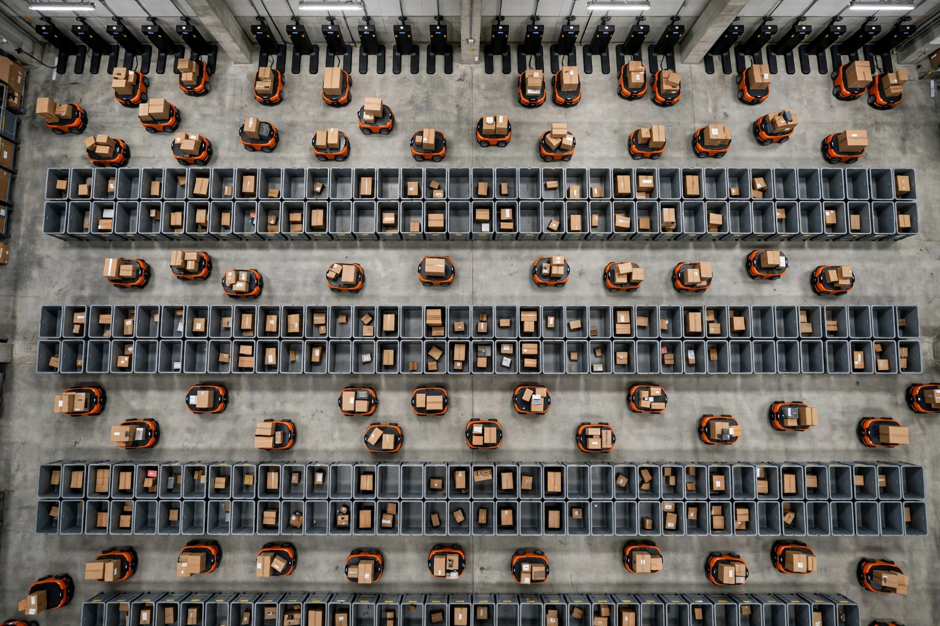 Overhead view of small parcel sorting robots working a chute grid